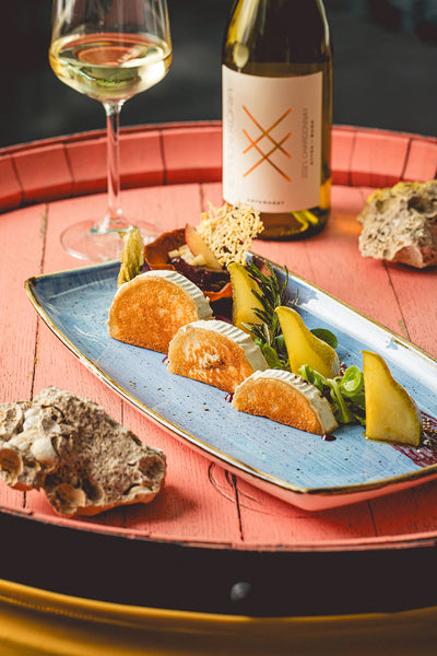Grilled goat cheese with rosemary pear and orange plum tartlet.